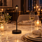 Black Perch cordless table lamp glowing on a dining table