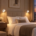 Pair of white Twin Sconce rechargeable wall lights glowing either side of a bed