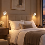 Pair of white Twin Sconce rechargeable wall lights glowing either side of a bed